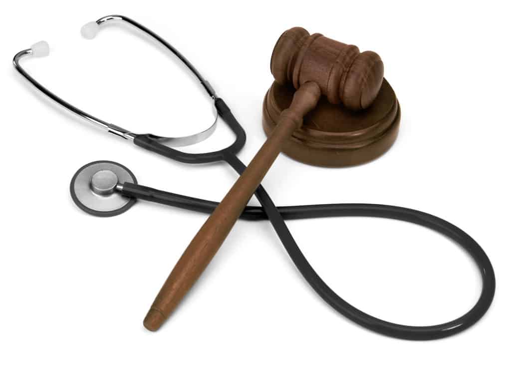 gavel and stethescope on white background